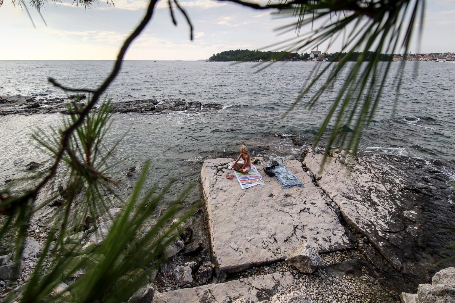 Woman relaxing on the shoreline in Istria