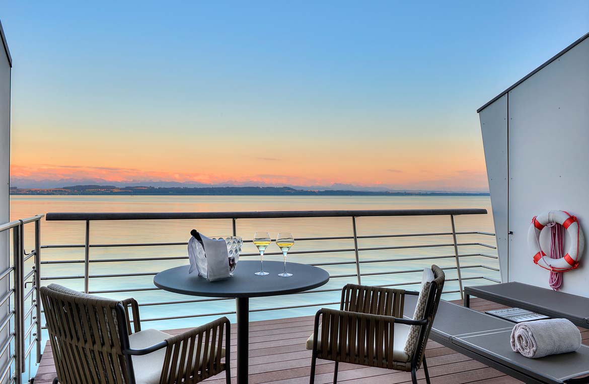 Wine bottle on table overlooking lake